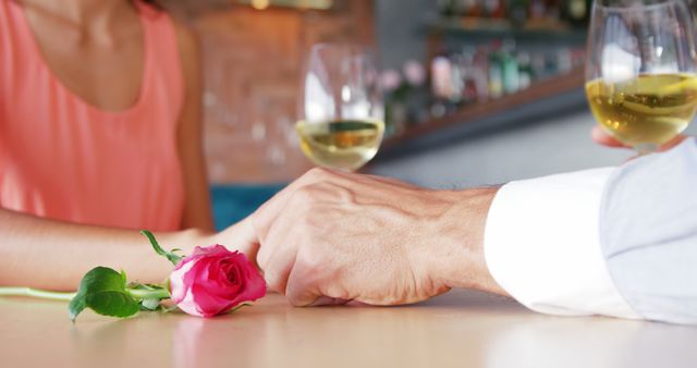 Romantic Couple Holding Hands with Wine Glasses and Rose - Download Free Stock Images Pikwizard.com
