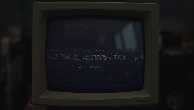 Retro CRT Monitor Displaying Static in Workshop Setting