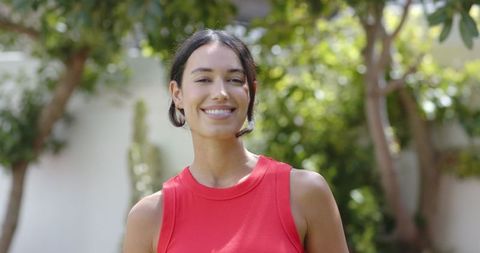 Woman Relaxing in Sunny Backyard Garden with Verdant Foliage