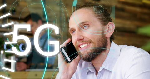 Smiling man using smartphone with 5g connectivity overlay
