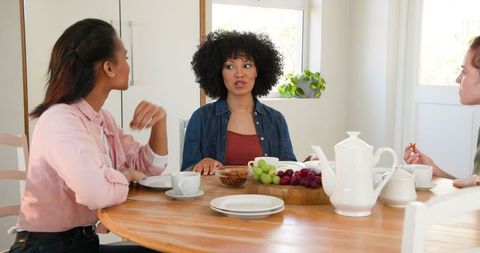 Diverse Friends Enjoying Conversation Over Breakfast Table