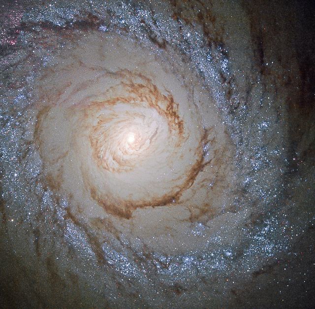 This image shows the galaxy Messier 94, which lies in the small northern constellation of the Hunting Dogs, about 16 million light-years away.  Within the bright ring or starburst ring around Messier 94, new stars are forming at a high rate and many young, bright stars are present within it.  The cause of this peculiarly shaped star-forming region is likely a pressure wave going outwards from the galactic center, compressing the gas and dust in the outer region. The compression of material means the gas starts to collapse into denser clouds. Inside these dense clouds, gravity pulls the gas and dust together until temperature and pressure are high enough for stars to be born.  Image credit: ESA/NASA  <b><a href="http://www.nasa.gov/audience/formedia/features/MP_Photo_Guidelines.html" rel="nofollow">NASA image use policy.</a></b>  <b><a href="http://www.nasa.gov/centers/goddard/home/index.html" rel="nofollow">NASA Goddard Space Flight Center</a></b> enables NASA’s mission through four scientific endeavors: Earth Science, Heliophysics, Solar System Exploration, and Astrophysics. Goddard plays a leading role in NASA’s accomplishments by contributing compelling scientific knowledge to advance the Agency’s mission.  <b>Follow us on <a href="http://twitter.com/NASAGoddardPix" rel="nofollow">Twitter</a></b>  <b>Like us on <a href="http://www.facebook.com/pages/Greenbelt-MD/NASA-Goddard/395013845897?ref=tsd" rel="nofollow">Facebook</a></b>  <b>Find us on <a href="http://instagrid.me/nasagoddard/?vm=grid" rel="nofollow">Instagram</a></b>  