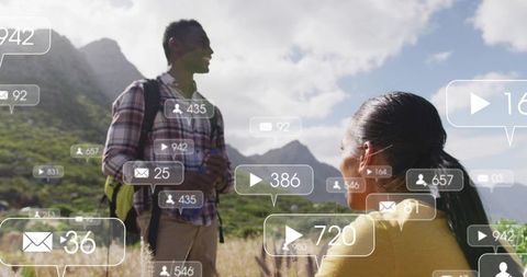 Couple hiking in mountain meadow with social media notifications overlaying outdoor adventure