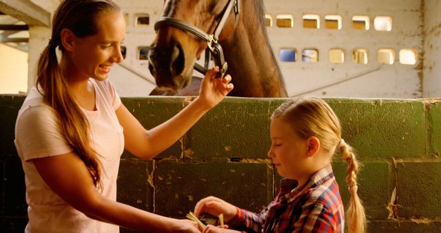 Mother and Daughter Feeding Horse in Barn - Download Free Stock Images Pikwizard.com