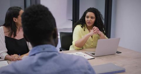 Diverse Team Engaged in Corporate Discussion in Modern Office