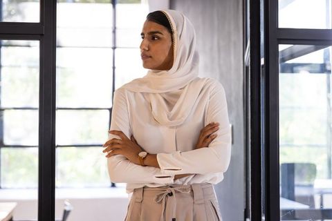 Confident Businesswoman in Modern Office Gazing Thoughtfully