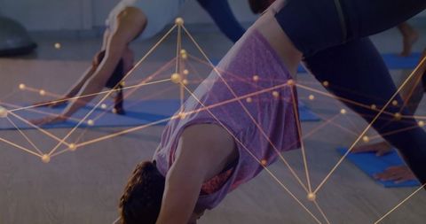 Women in Yoga Studio Performing Downward Dog with Futuristic Network Design