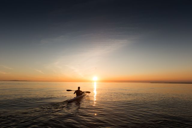 Person Kayaking on Calm Sea at Sunset - Download Free Stock Photos Pikwizard.com