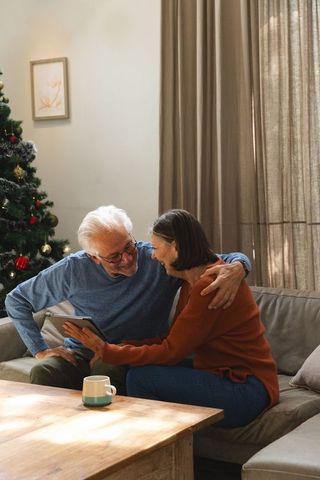 Senior Couple Enjoying Cozy Holiday Moment with Tablet