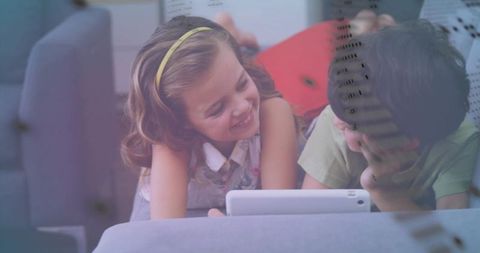 Happy Siblings Enjoying Tablet in Cozy Living Room