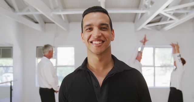 Smiling Dance Instructor in Studio with Class in Background - Download Free Stock Images Pikwizard.com