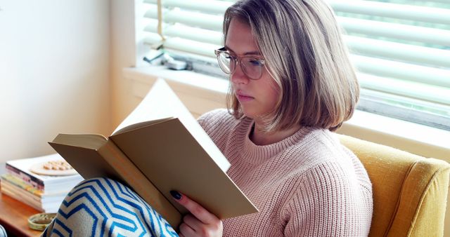 Young Woman Reading Book Near Window - Download Free Stock Images Pikwizard.com