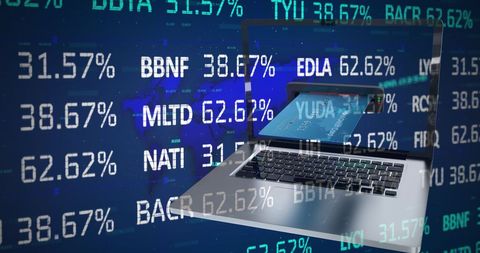 Laptop with credit card and digital financial data overlay