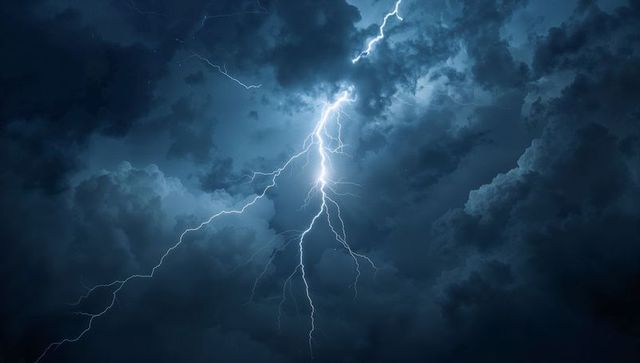 Dramatic Lightning Bolt Illuminates Storm Clouds in Night Sky