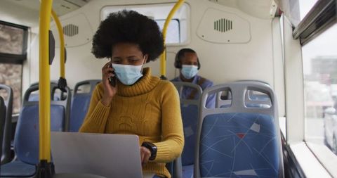 Businesswoman on Bus with Laptop and Phone During Pandemic Travel - Download Free Stock Images Pikwizard.com