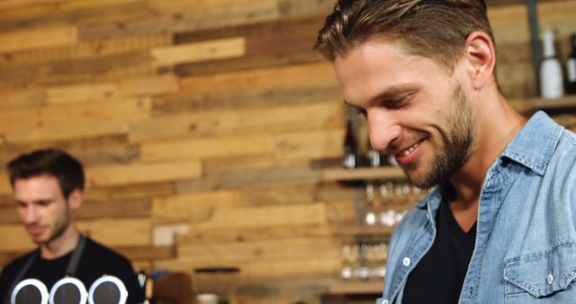 Smiling Man in Denim Shirt at Modern Cafe - Download Free Stock Images Pikwizard.com