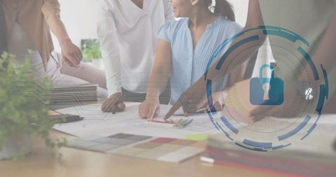 Diverse team of designers collaborating on blueprint project in office