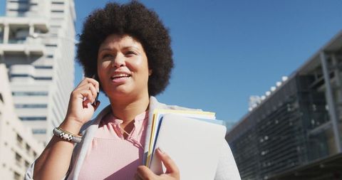 Confident and successful woman embracing career in urban setting
