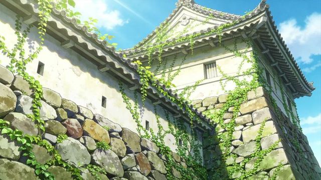 Ivy-climbing stone castle tower basking in sunlight with weathered masonry and blue sky