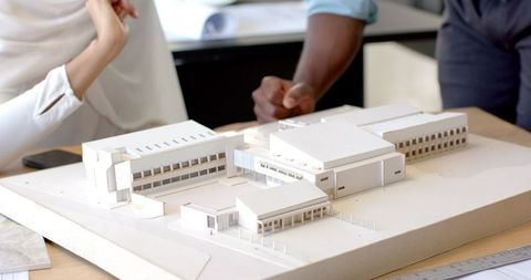 Professionals Discussing Detailed Architectural Model in Office - Download Free Stock Images Pikwizard.com