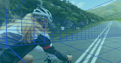 Female cyclist riding through scenic mountain roadway