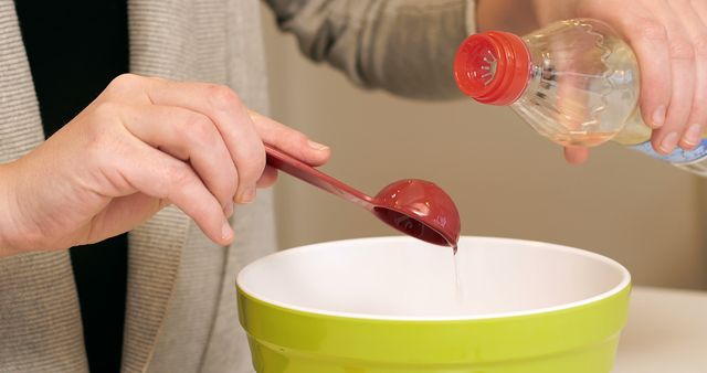 Measuring and Pouring Liquid into Mixing Bowl - Download Free Stock Images Pikwizard.com