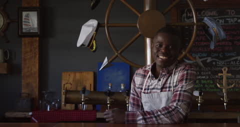 Smiling Barman Serving at Microbrewery Pub