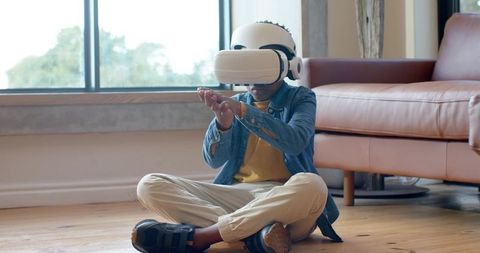 African American Boy Experiencing Immersive Virtual Reality in Cozy Living Room