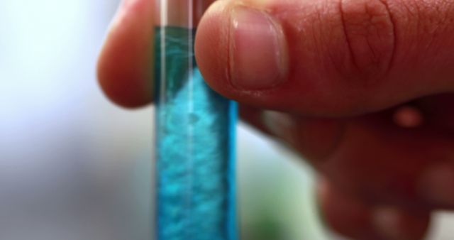 Scientist Holding Test Tube with Blue Liquid in Laboratory - Download Free Stock Images Pikwizard.com