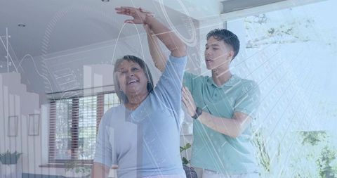 Caregiver guiding senior woman through arm stretching with digital health overlay