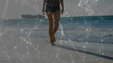 Digital Connections Overlaid on Woman Walking on Beach