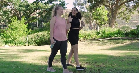 Women Exercising Outdoors for Fitness and Friendship in Sunny Park