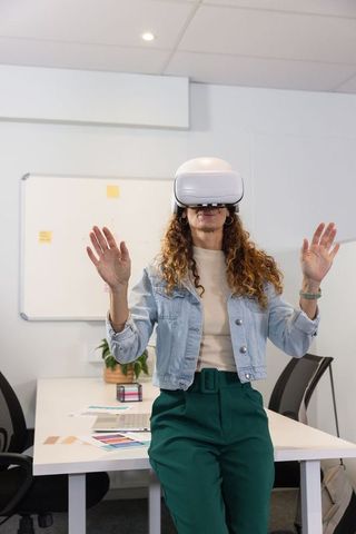 Designer Wearing VR Headset in Office Exploring Color Swatches and Digital Interface