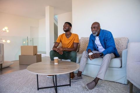 Father and Son Relaxing After Moving Day in Cozy New Home