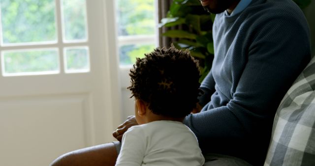 Father and Toddler Relaxing Together Near Window at Home - Download Free Stock Images Pikwizard.com