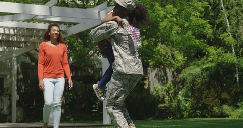 Returning Soldier Embracing Daughter by Outdoor Pathway - Download Free Stock Images Pikwizard.com