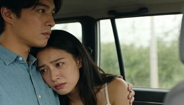 Couple embracing in car after emotional moment, woman crying, supportive comfort