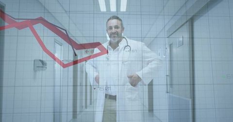 Standing male doctor in hospital corridor with red analytics graph overlay showing decline