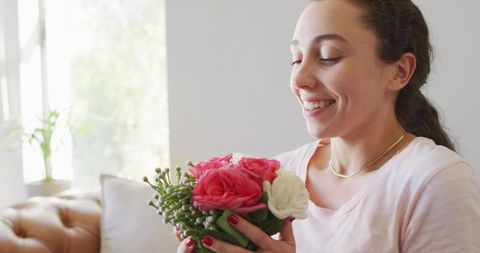Happy Woman Smelling Flower Bouquet in Sunlit Room - Download Free Stock Images Pikwizard.com
