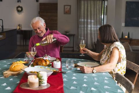 Senior Couple Enjoying Festive Dining Experience at Xmas Home