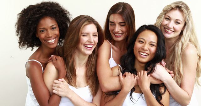 Diverse Group of Women Smiling and Hugging Each Other in White Shirts - Download Free Stock Images Pikwizard.com