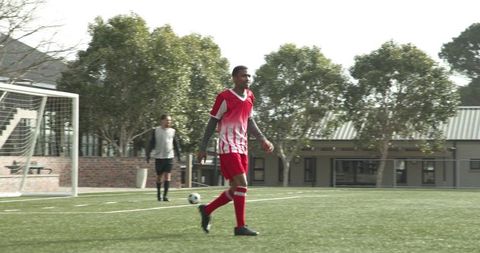 Youth players competing in schoolyard soccer match