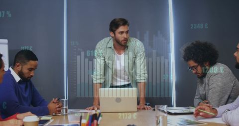 Diverse Business Team Analyzing Growth with Digital Graphics