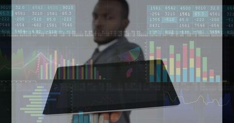 Futuristic businessman holding tablet with analytics overlay