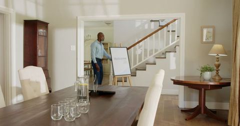 Senior Friends Setting Up Welcome Sign at Home Gathering