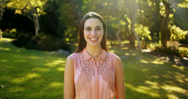 Smiling Woman Standing in Sunlit Park - Download Free Stock Images Pikwizard.com