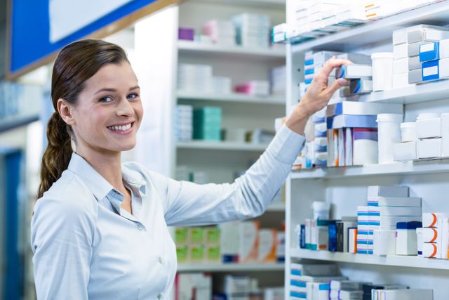 Portrait of pharmacist checking a medicine in pharmacy
