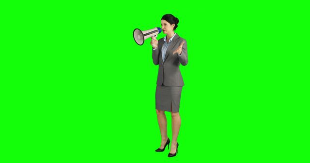 A middle-aged Caucasian businesswoman is speaking into a megaphone, with copy space. Her assertive stance and formal attire suggest a context of leadership or announcement.
