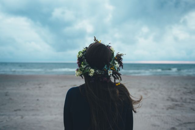 Woman Wearing Floral Crown Viewing Ocean on Overcast Day - Download Free Stock Images Pikwizard.com
