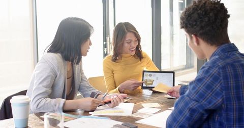 Creative Team Collaborating in Modern Office with Digital Tablet